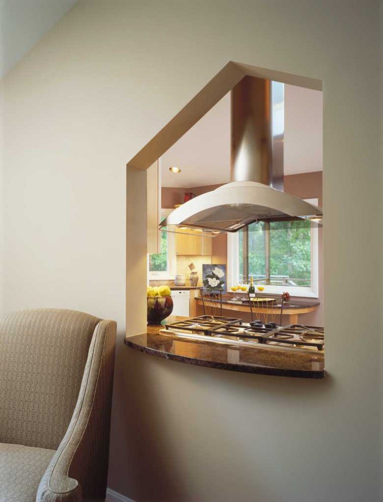 SITTING ROOM INTERIOR WINDOW SHAPED BY TILE DESIGN ON KITCHEN SIDE.